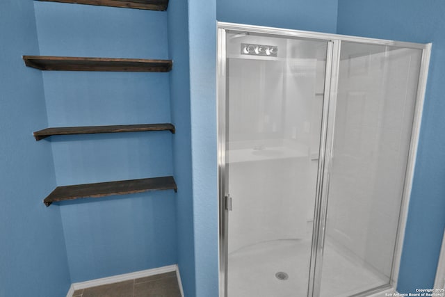 bathroom featuring an enclosed shower and tile patterned floors