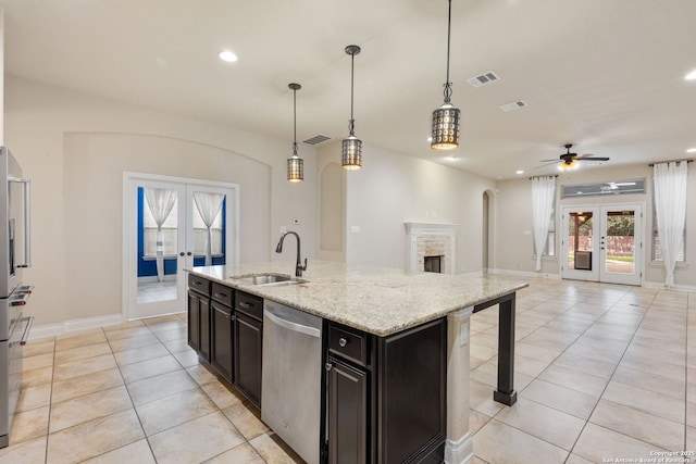 kitchen featuring dishwasher, french doors, a sink, and visible vents