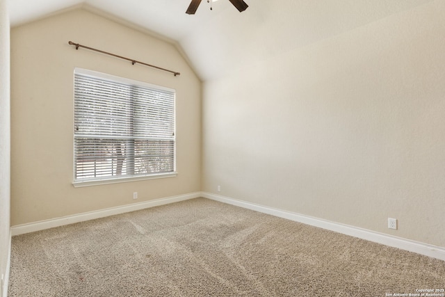 carpeted spare room featuring lofted ceiling, a ceiling fan, and baseboards