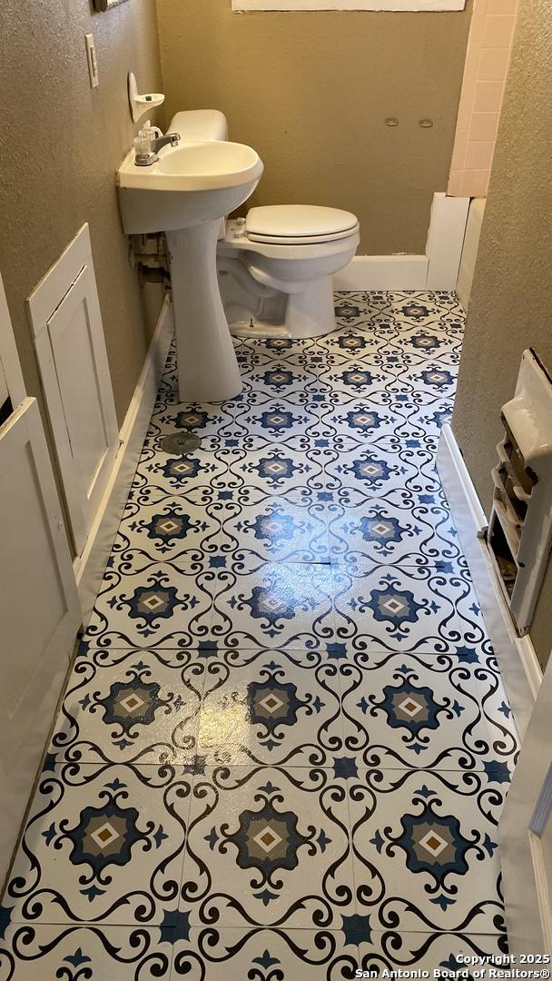 bathroom with tile patterned floors and toilet