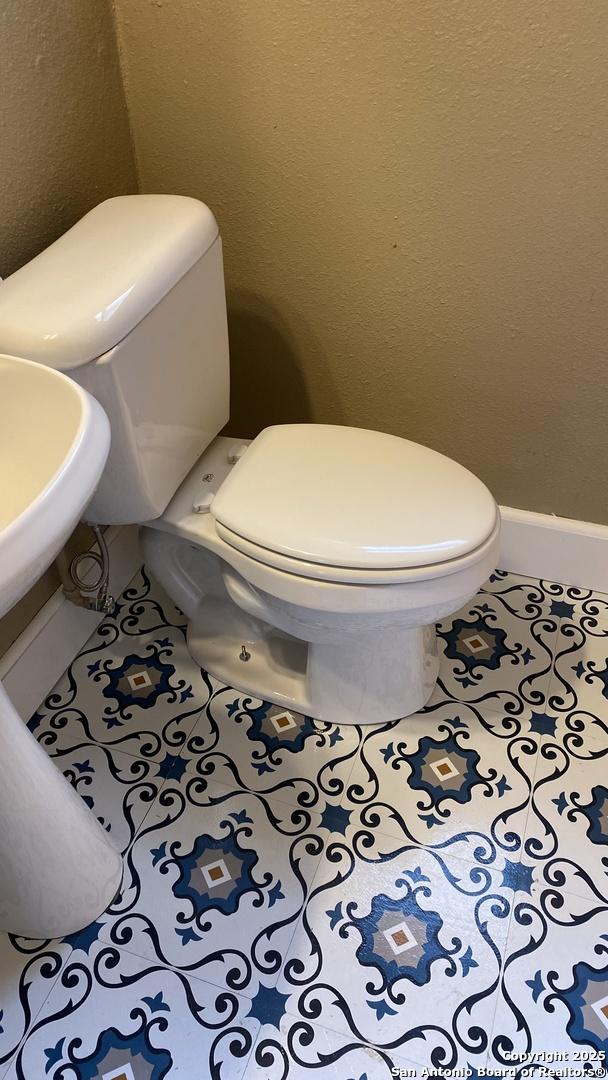 bathroom featuring toilet and tile patterned floors