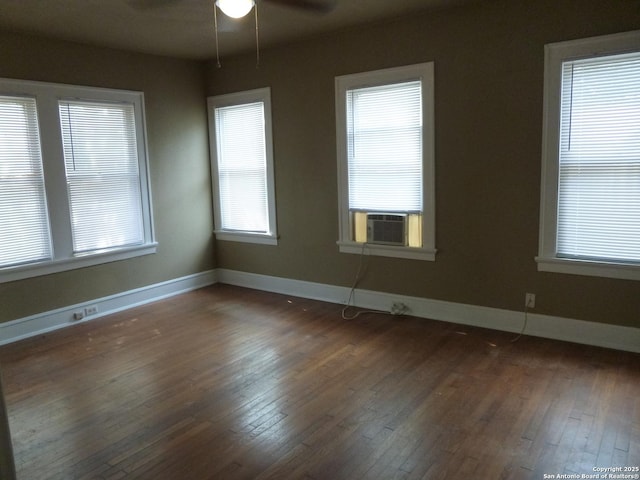 unfurnished room with cooling unit, ceiling fan, and dark wood-type flooring