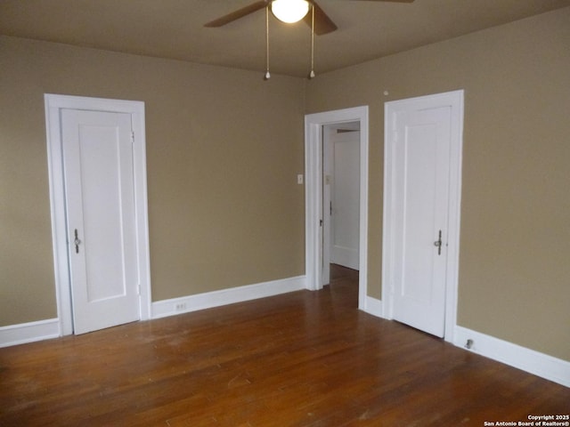 empty room featuring ceiling fan and dark hardwood / wood-style flooring