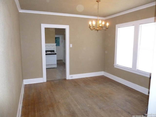 empty room featuring an inviting chandelier, crown molding, and dark hardwood / wood-style floors