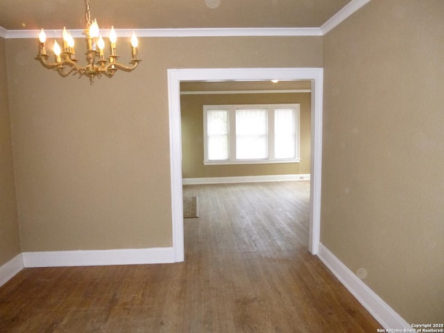 unfurnished dining area with wood-type flooring, a chandelier, and crown molding