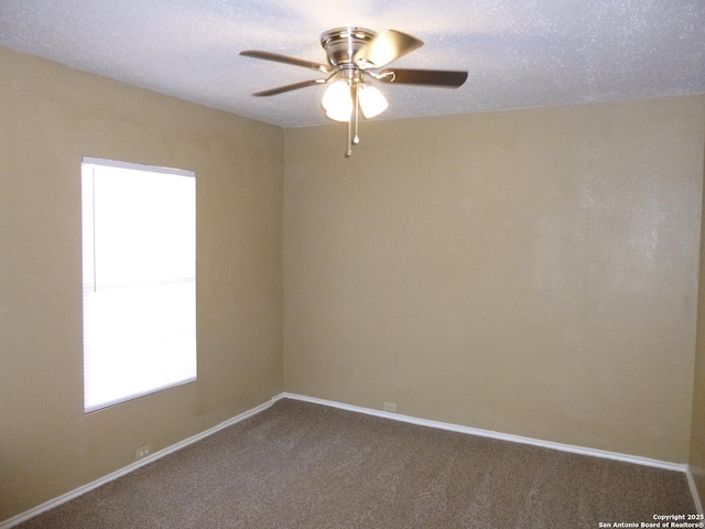 empty room with a textured ceiling, carpet flooring, and ceiling fan