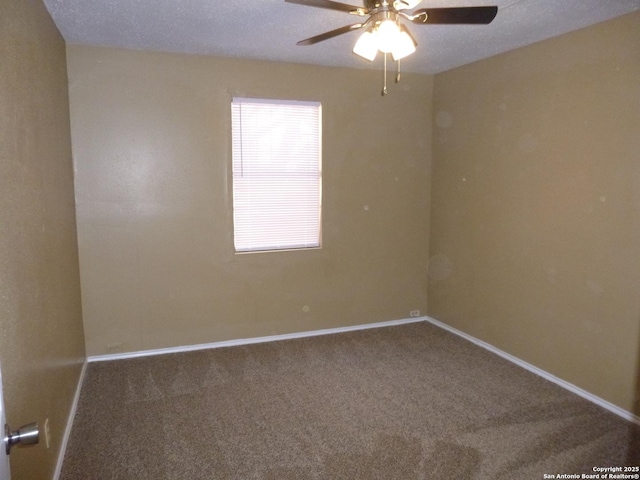 carpeted empty room featuring ceiling fan and a textured ceiling