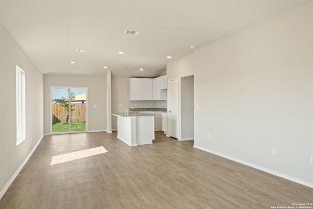 1836 Charlie Cv, San Antonio, TX 78221 - unfurnished living room featuring light wood-type flooring