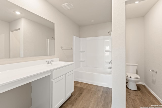 1836 Charlie Cv, San Antonio, TX 78221 - full bathroom featuring hardwood / wood-style flooring, vanity, toilet, and washtub / shower combination