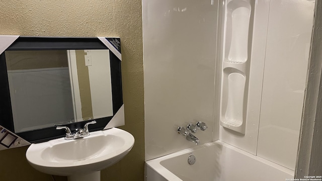 bathroom with sink and shower / washtub combination