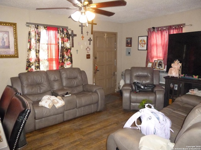 living room featuring a textured ceiling, ceiling fan, and dark hardwood / wood-style flooring