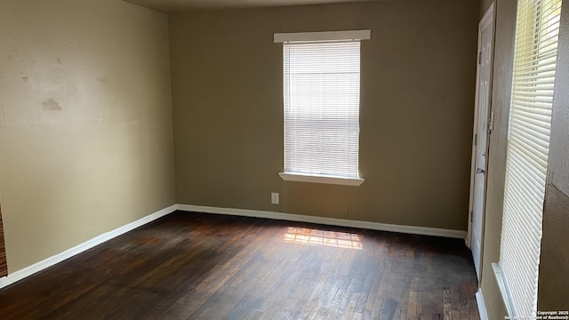 unfurnished room with dark hardwood / wood-style flooring