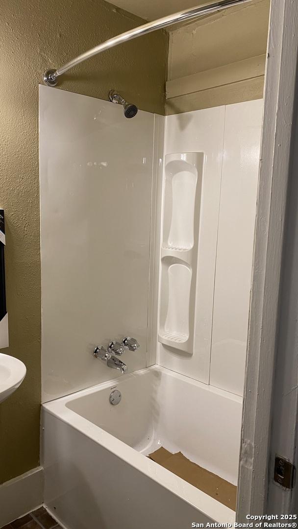 bathroom with shower / bathing tub combination