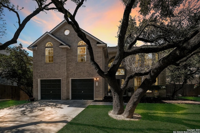 view of front of house with a garage and a lawn