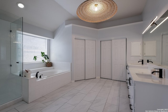 bathroom with vanity, shower with separate bathtub, and lofted ceiling