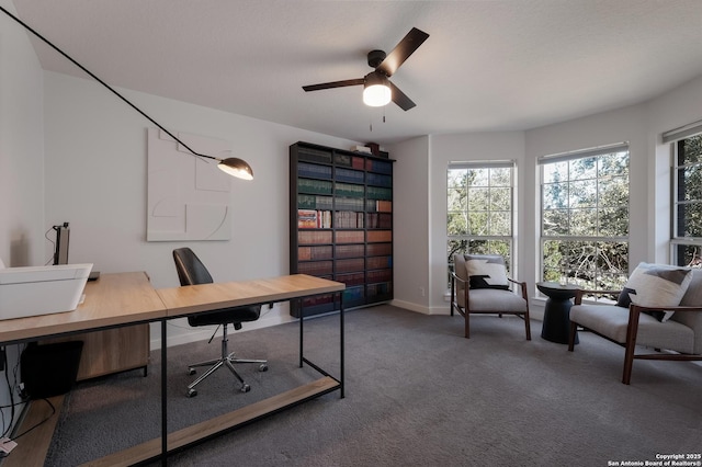 carpeted home office with ceiling fan