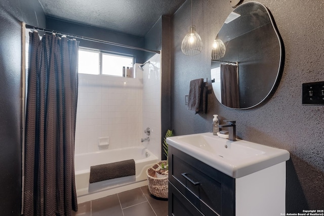 bathroom featuring shower / bath combination with curtain, tile patterned flooring, vanity, and a textured ceiling