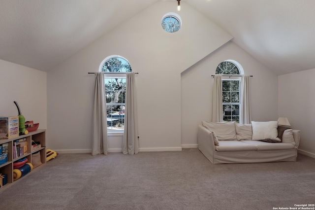 sitting room featuring plenty of natural light, light carpet, and lofted ceiling