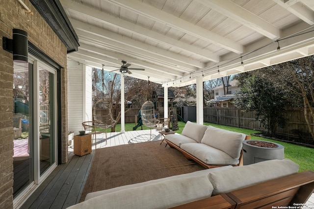 deck with an outdoor living space with a fire pit and ceiling fan