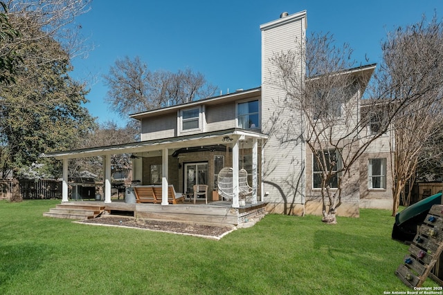 back of house featuring outdoor lounge area, a yard, and a deck