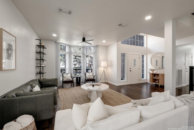 living room featuring dark hardwood / wood-style flooring and ceiling fan