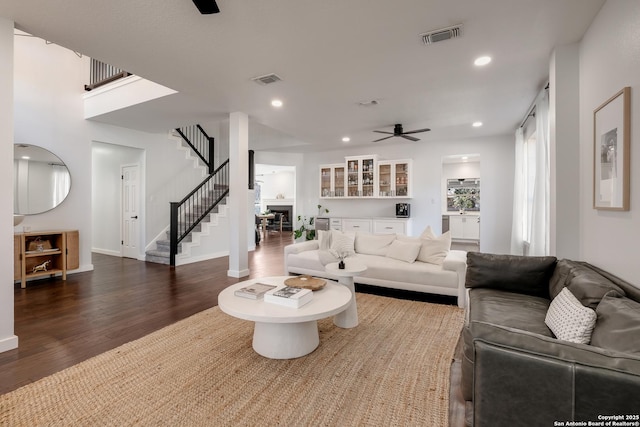 living room with ceiling fan and dark hardwood / wood-style floors