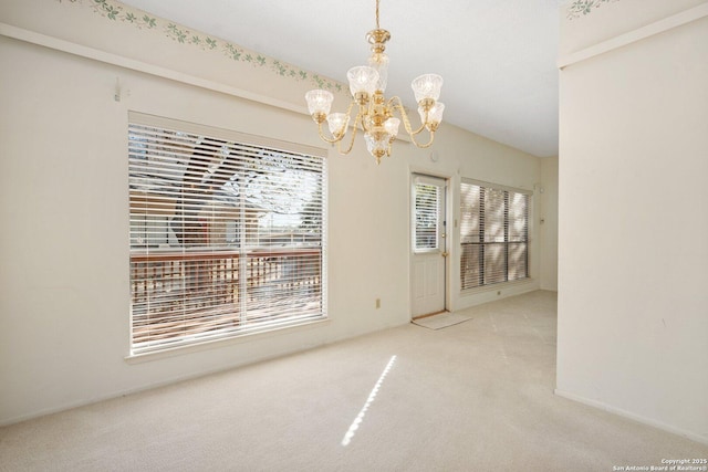 unfurnished dining area with a chandelier and carpet