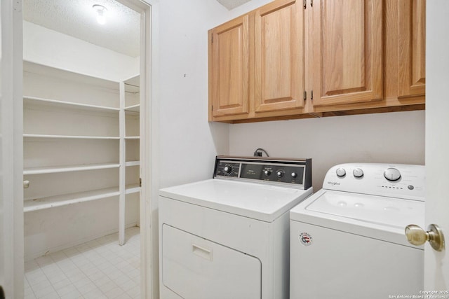 laundry area with washing machine and dryer and cabinet space