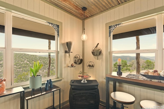 bathroom with wooden ceiling, a mountain view, and wood walls