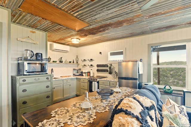 kitchen with light stone counters, a wall unit AC, stainless steel appliances, backsplash, and open shelves