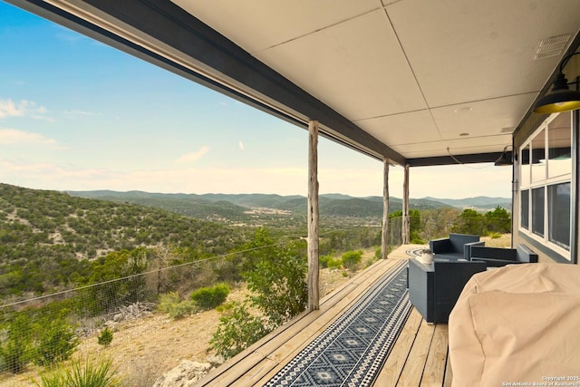 deck featuring a mountain view and an outdoor hangout area