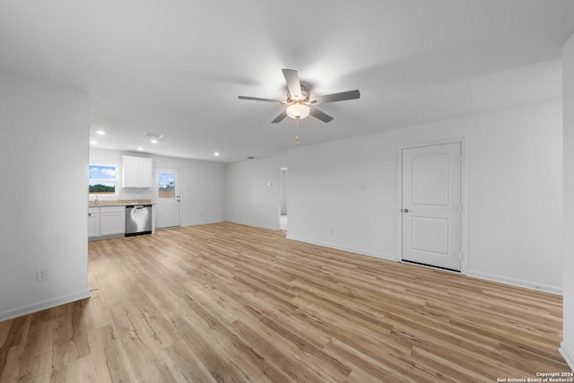 unfurnished living room with light hardwood / wood-style flooring, ceiling fan, and sink