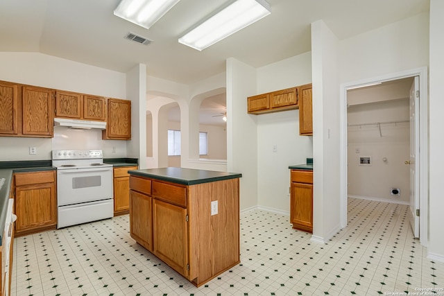 kitchen featuring a kitchen island, electric stove, vaulted ceiling, ceiling fan, and dishwasher