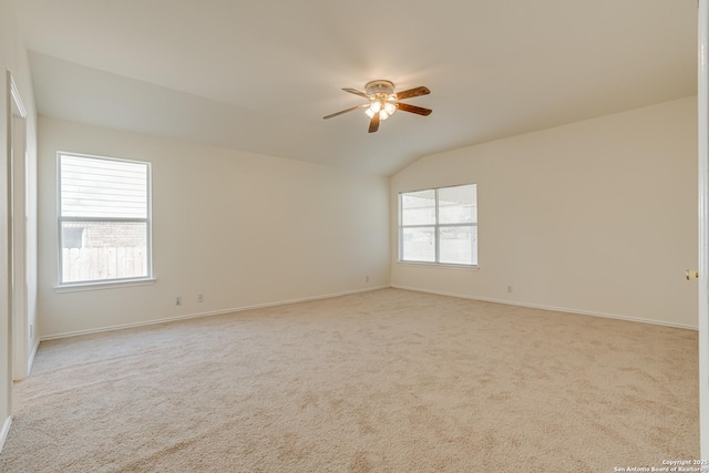 unfurnished room with light carpet, vaulted ceiling, and ceiling fan