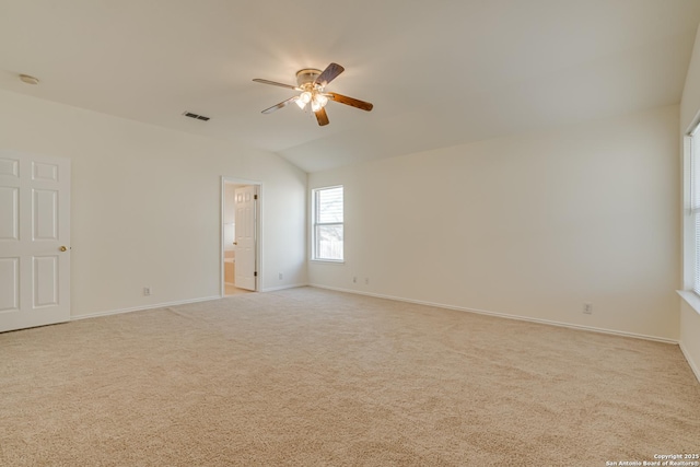 carpeted spare room featuring lofted ceiling and ceiling fan