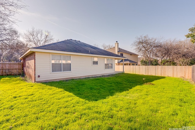 back of house with a yard