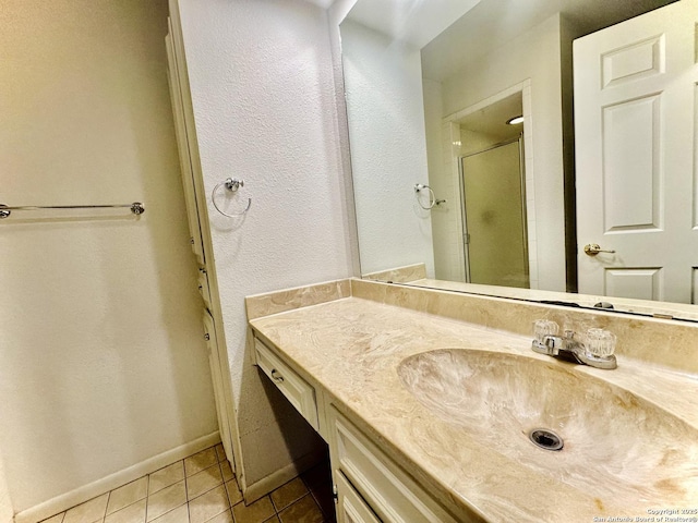 bathroom featuring tile patterned floors, vanity, and an enclosed shower