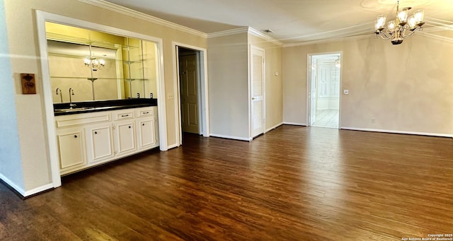 interior space featuring a notable chandelier, wet bar, crown molding, and dark hardwood / wood-style floors