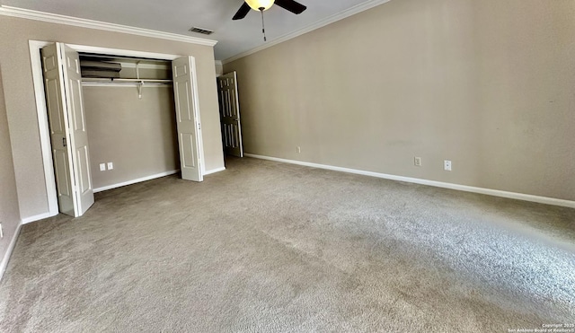 unfurnished bedroom with carpet, a closet, ceiling fan, and ornamental molding