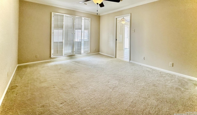 spare room with ceiling fan, ornamental molding, and carpet