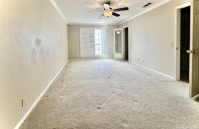 carpeted empty room featuring ceiling fan and ornamental molding