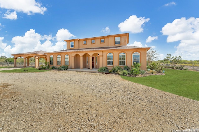 mediterranean / spanish-style house featuring a front lawn