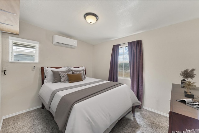 bedroom with a wall mounted air conditioner and carpet