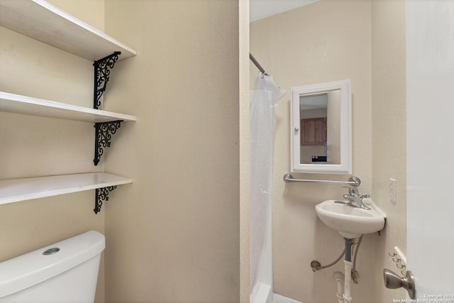 bathroom with toilet and walk in shower