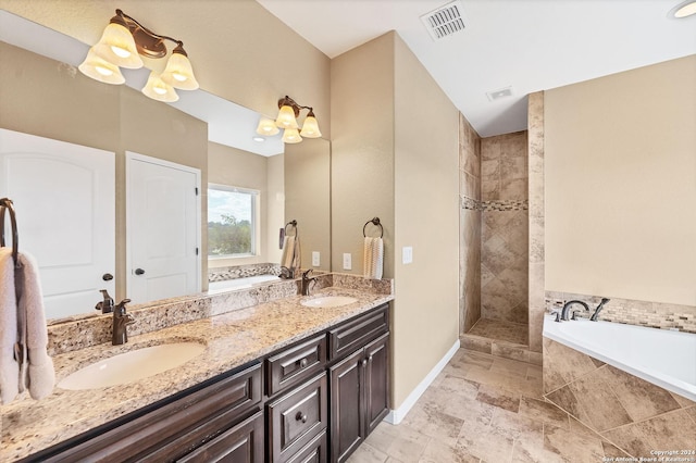 bathroom with vanity and independent shower and bath