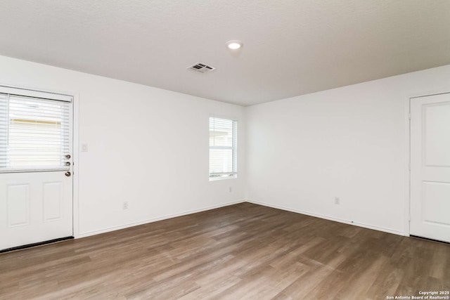 empty room featuring hardwood / wood-style flooring