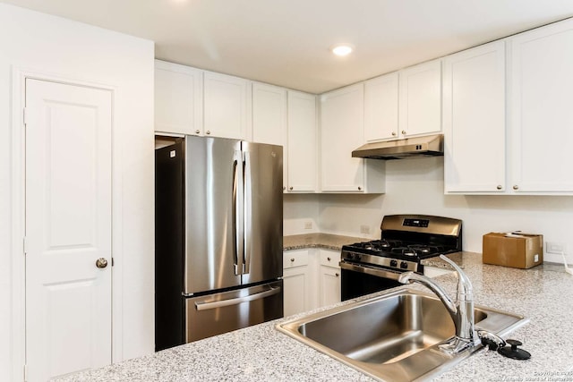 kitchen with appliances with stainless steel finishes, sink, and white cabinets