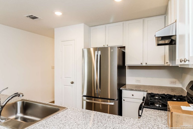 kitchen with white cabinetry, stainless steel appliances, butcher block counters, sink, and exhaust hood