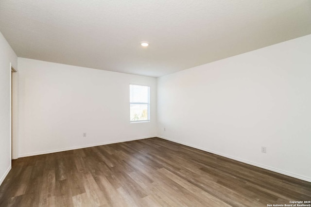 spare room featuring hardwood / wood-style floors