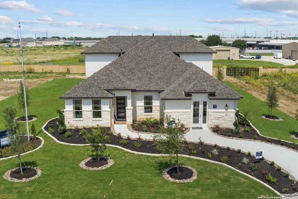 view of front of house with french doors and a front lawn